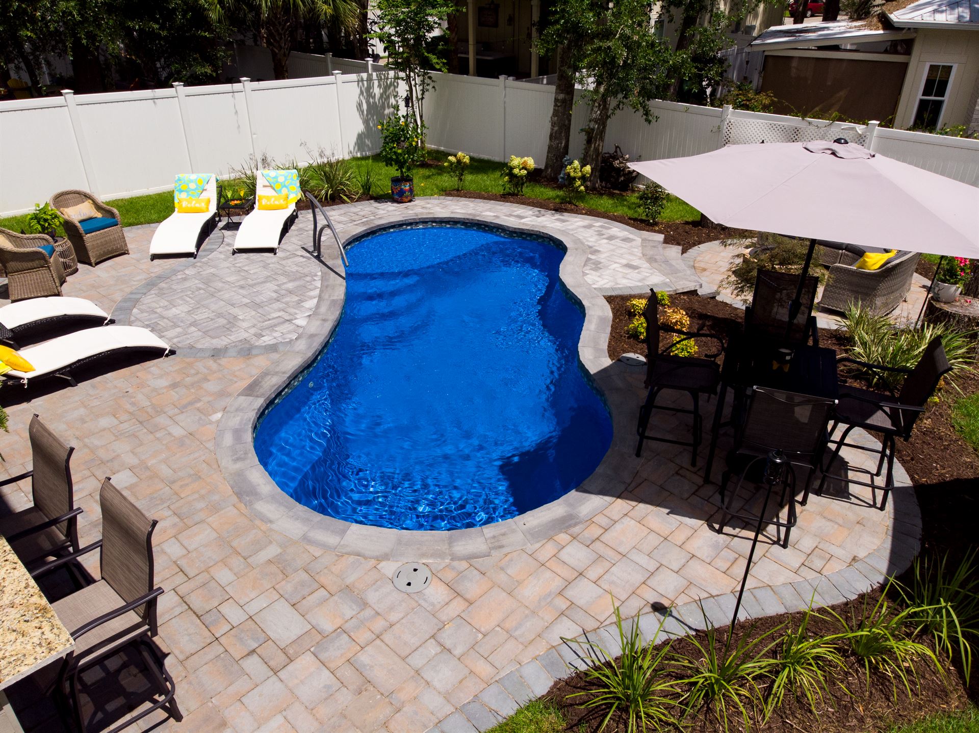 River Pools I25 in Maya Shimmer with concrete paver patio and coping