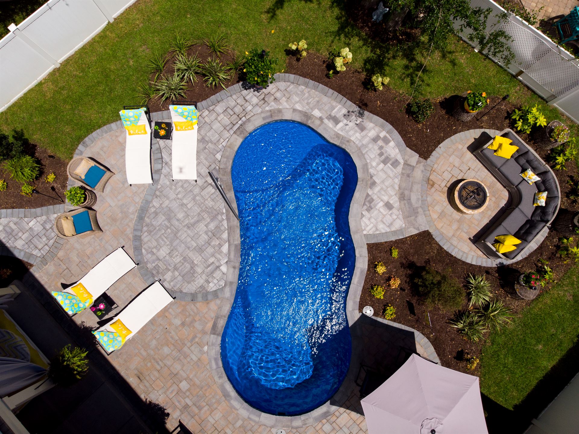 River Pools I25 in Maya Shimmer with concrete paver patio and coping