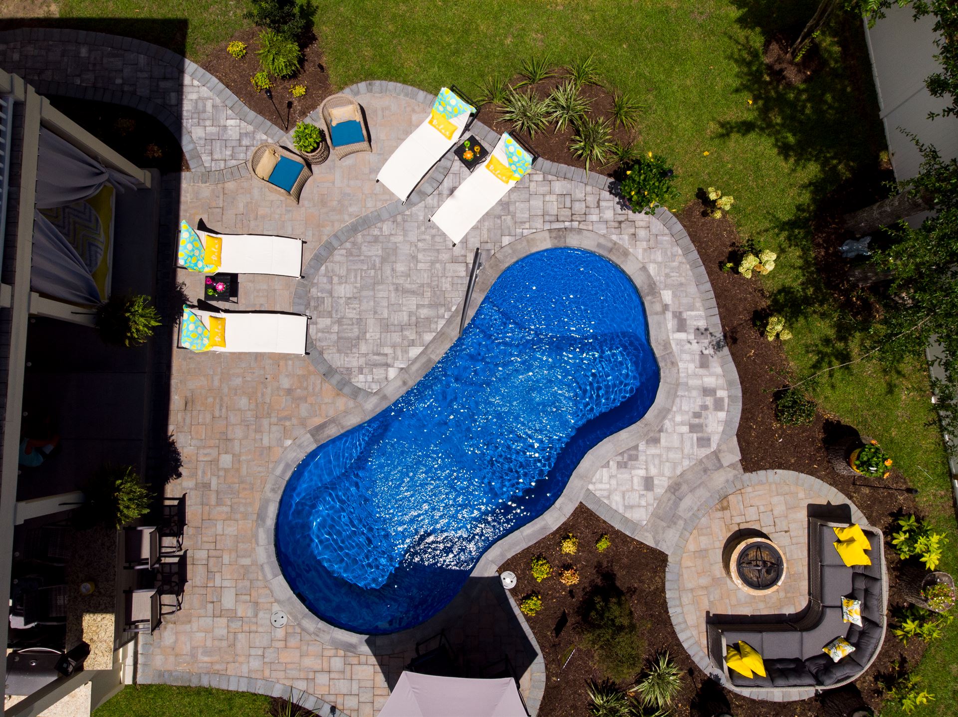 River Pools I25 in Maya Shimmer with concrete paver patio and coping