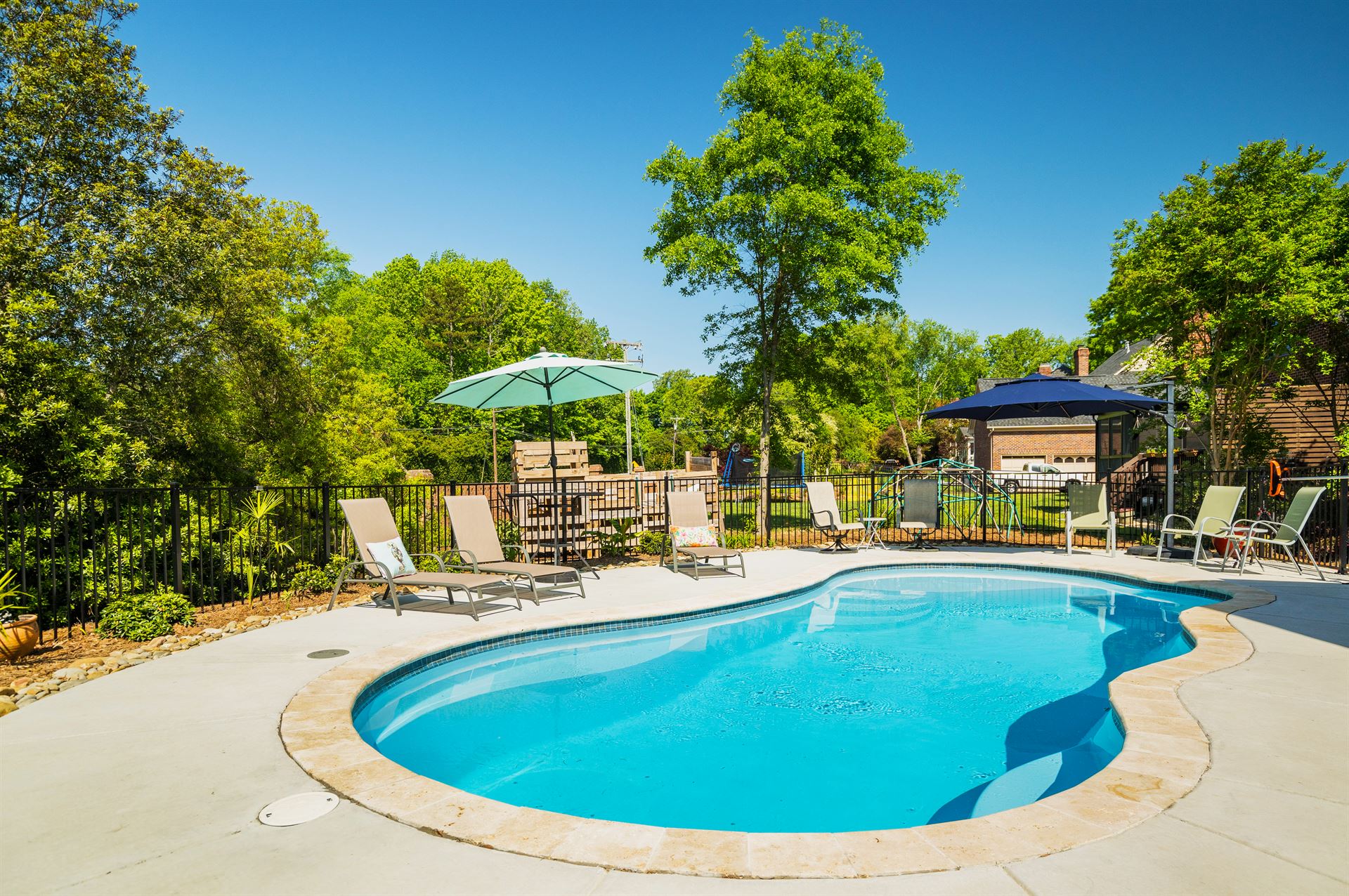 River Pools I30 in Caribbean Sparkle with brushed concrete and natural stone coping