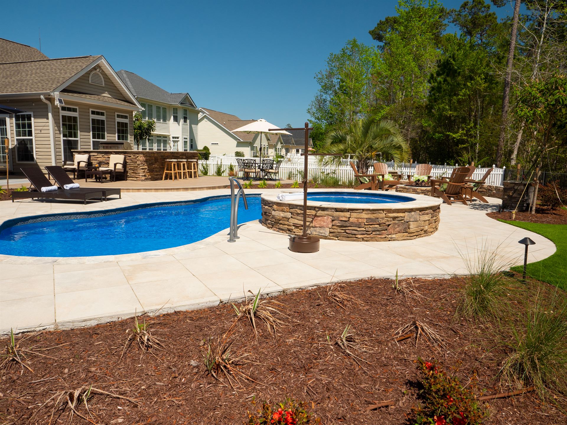 River Pools I30 + RS08 with spillway in Maya Shimmer with natural stone patio and coping