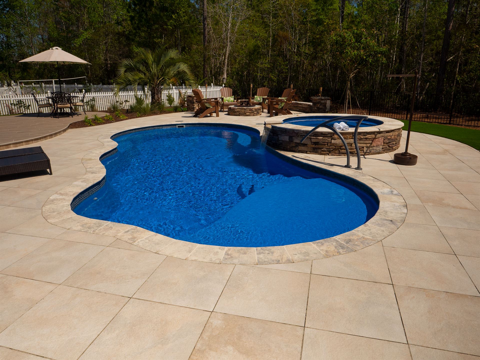 River Pools I30 + RS08 with spillway in Maya Shimmer with natural stone patio and coping