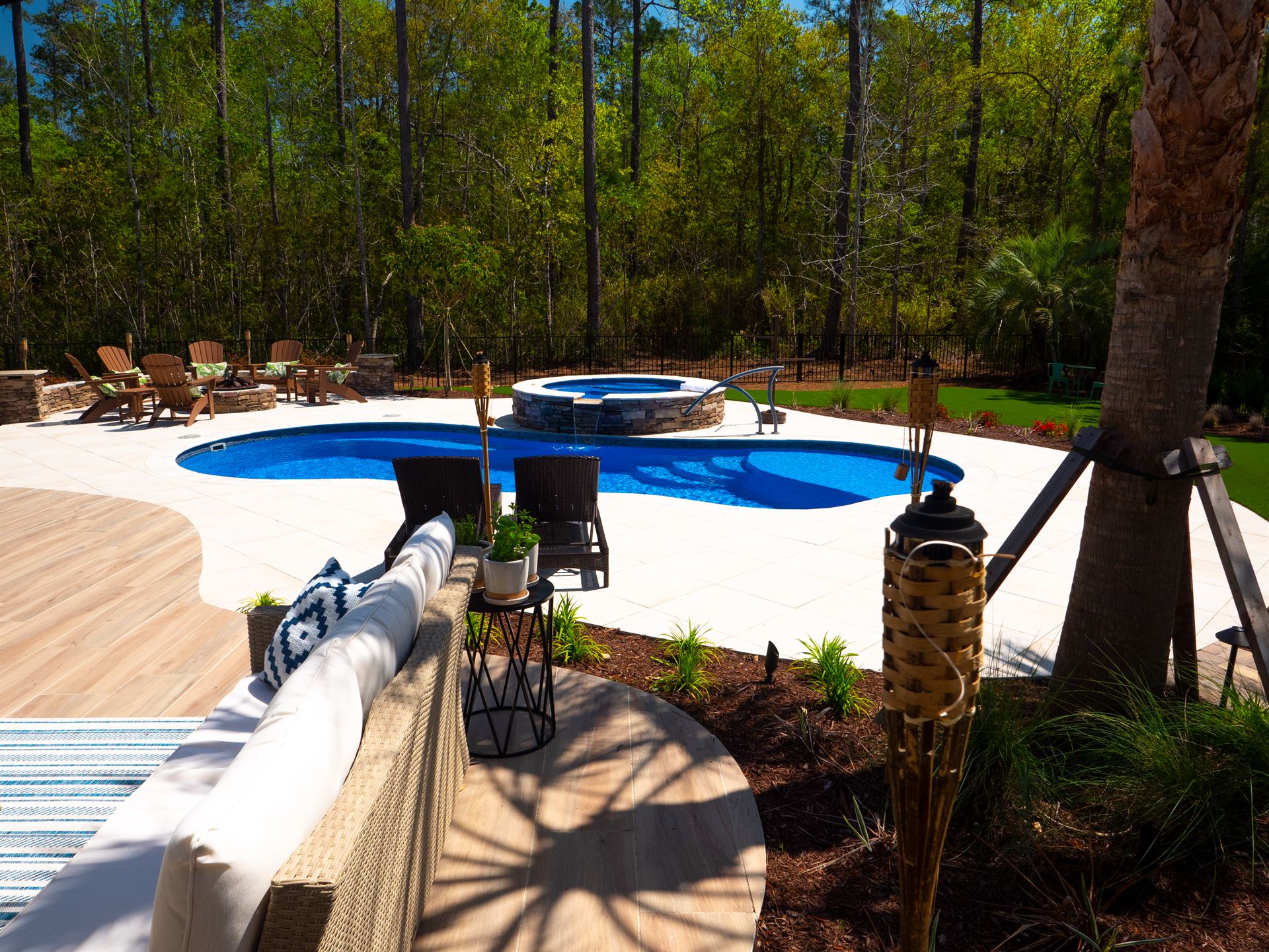 River Pools I30 + RS08 with spillway in Maya Shimmer with natural stone patio and coping