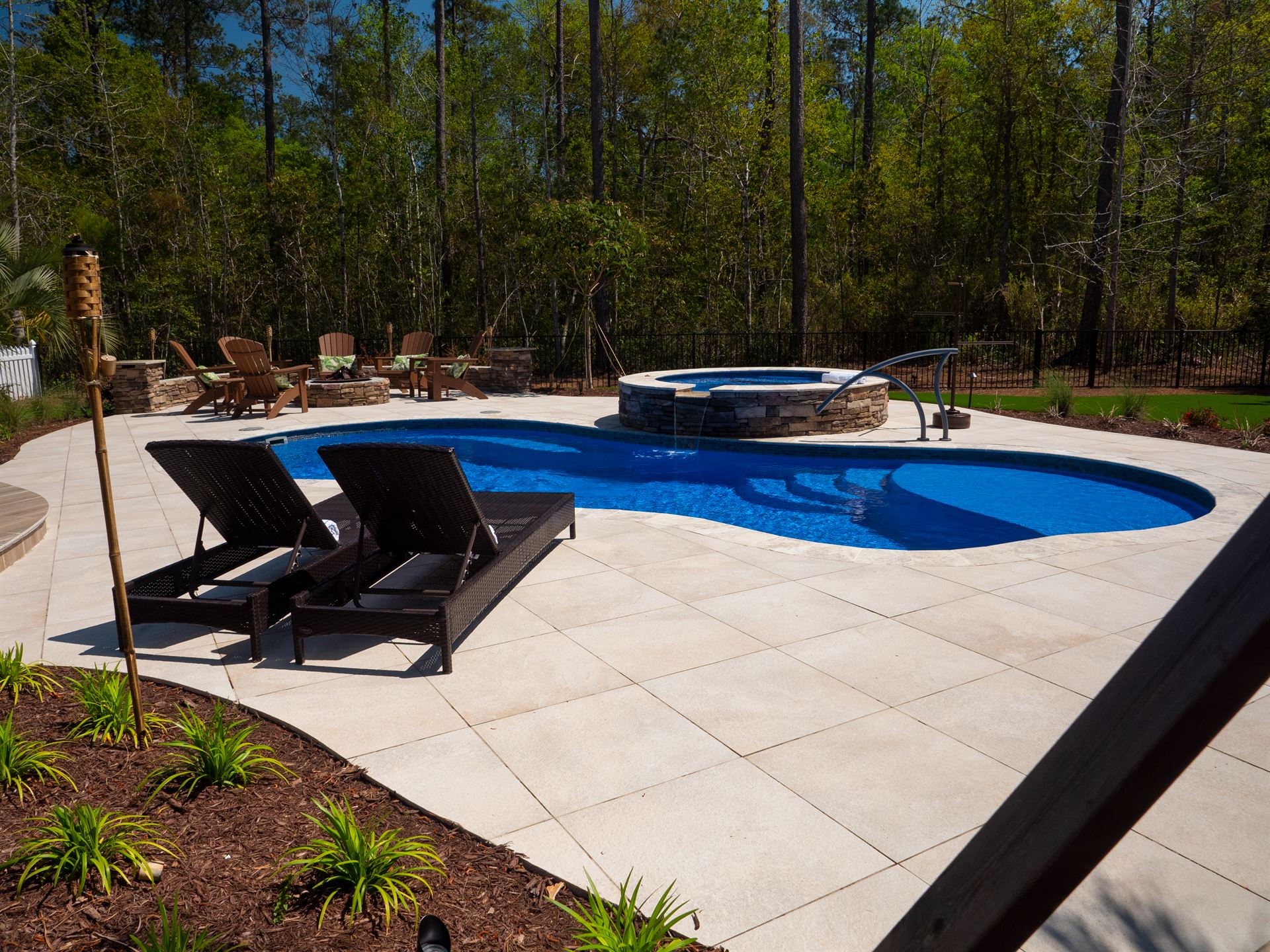 River Pools I30 + RS08 with spillway in Maya Shimmer with natural stone patio and coping