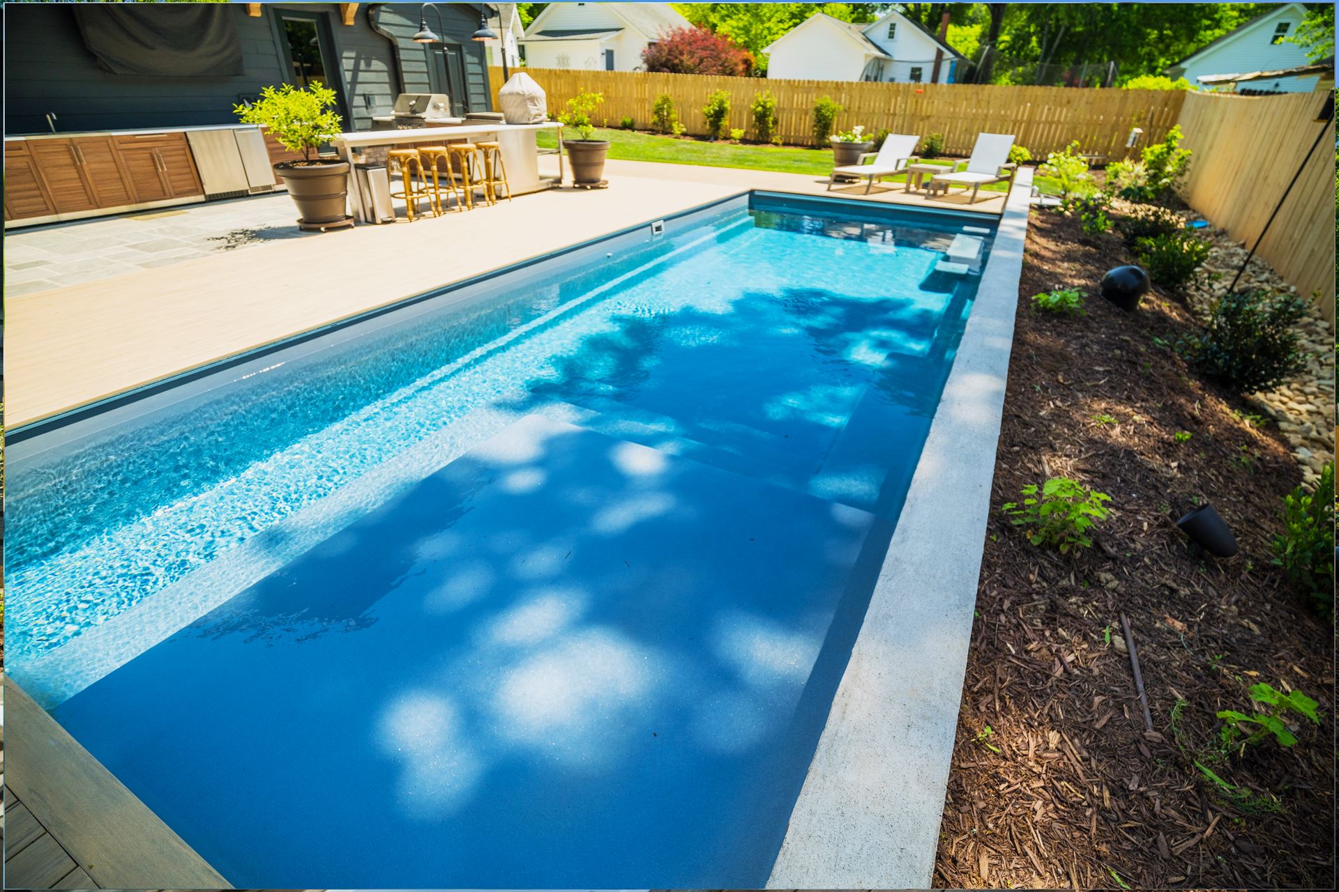 River Pools M35 in Granite Gray with composite wood patio and coping