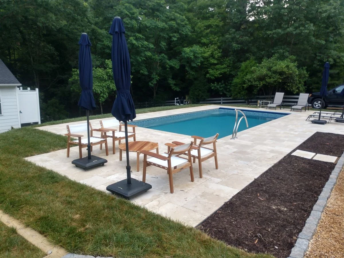 R28 pool in Granite Gray with travertine decking