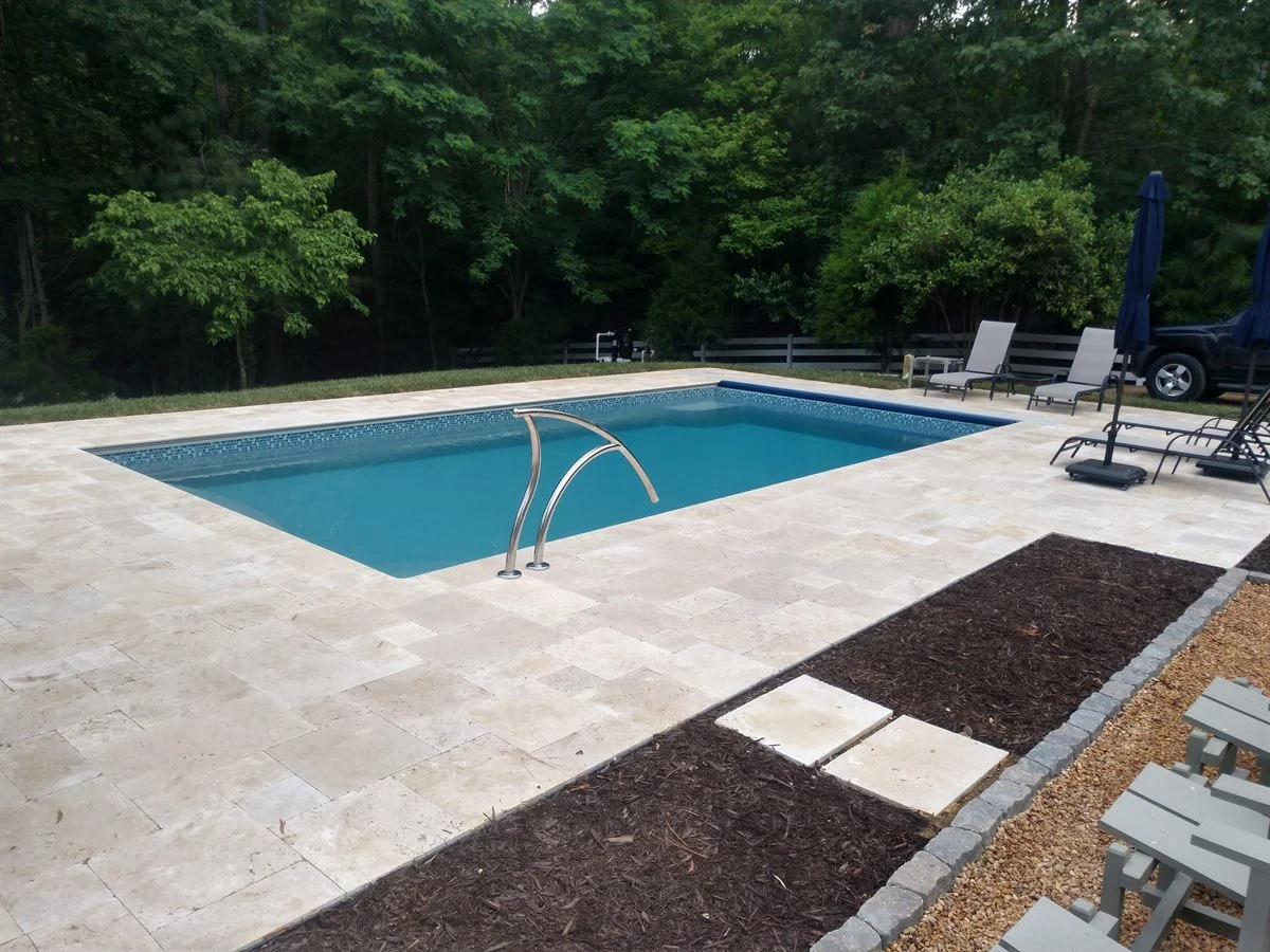 R28 pool in Granite Gray with travertine decking