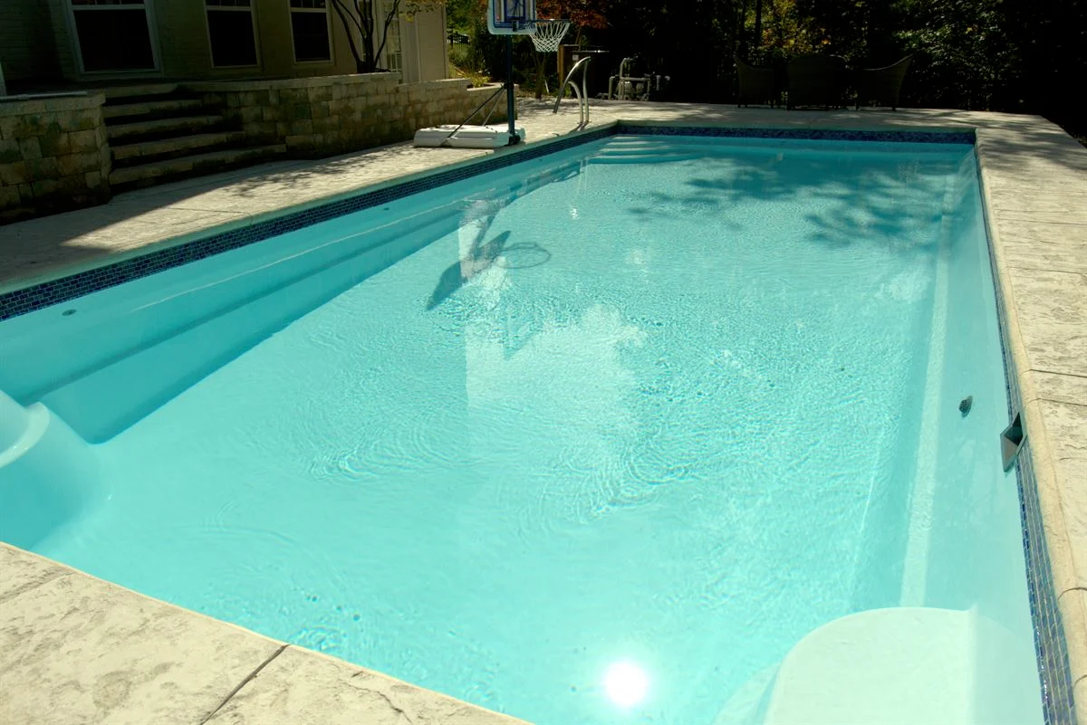 R36 pool in Arctic with textured concrete deck and waterline tile