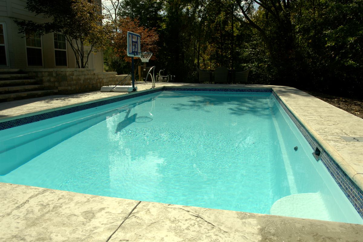 R36 pool in Arctic with textured concrete deck and waterline tile