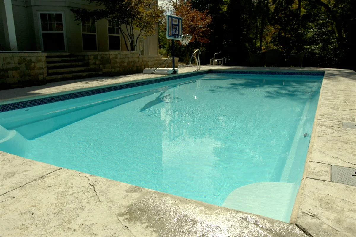 R36 pool in Arctic with textured concrete deck and waterline tile