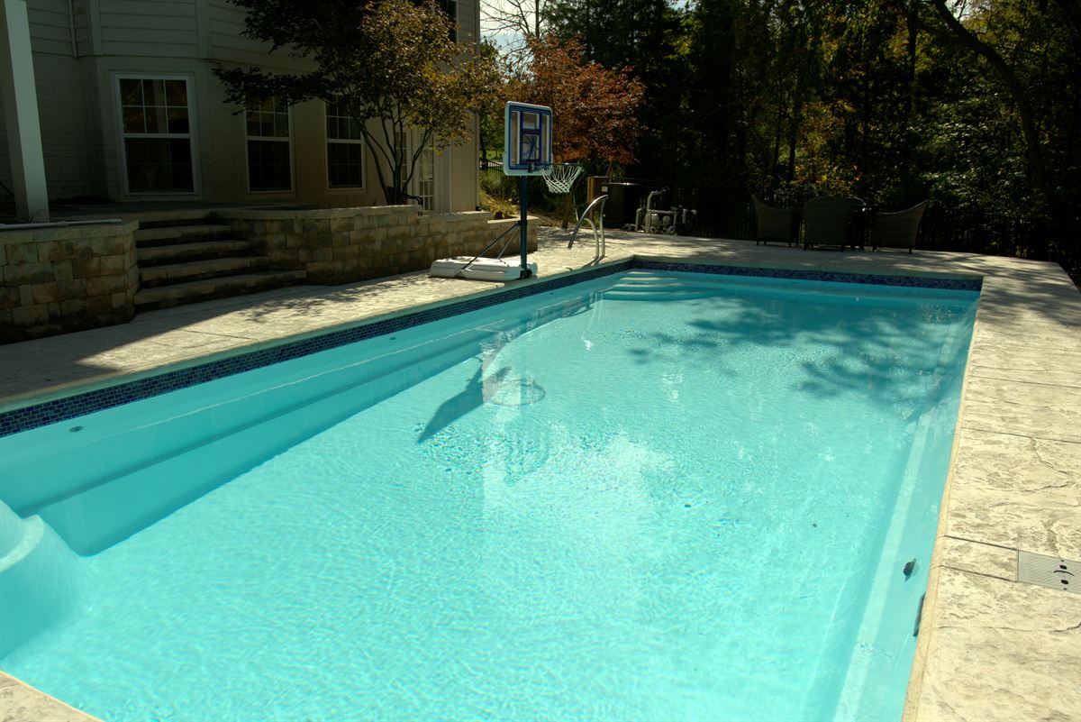 R36 pool in Arctic with textured concrete deck and waterline tile