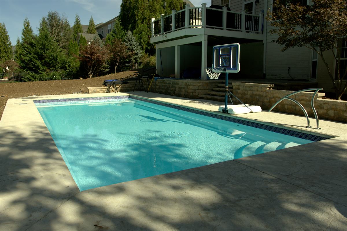 R36 pool in Arctic with textured concrete deck and waterline tile