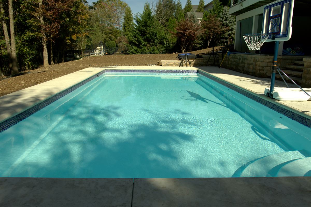 R36 pool in Arctic with textured concrete deck and waterline tile