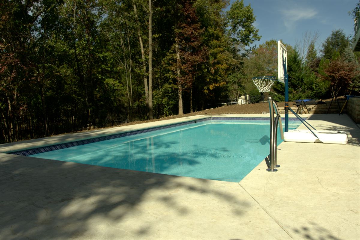 R36 pool in Arctic with textured concrete deck and waterline tile