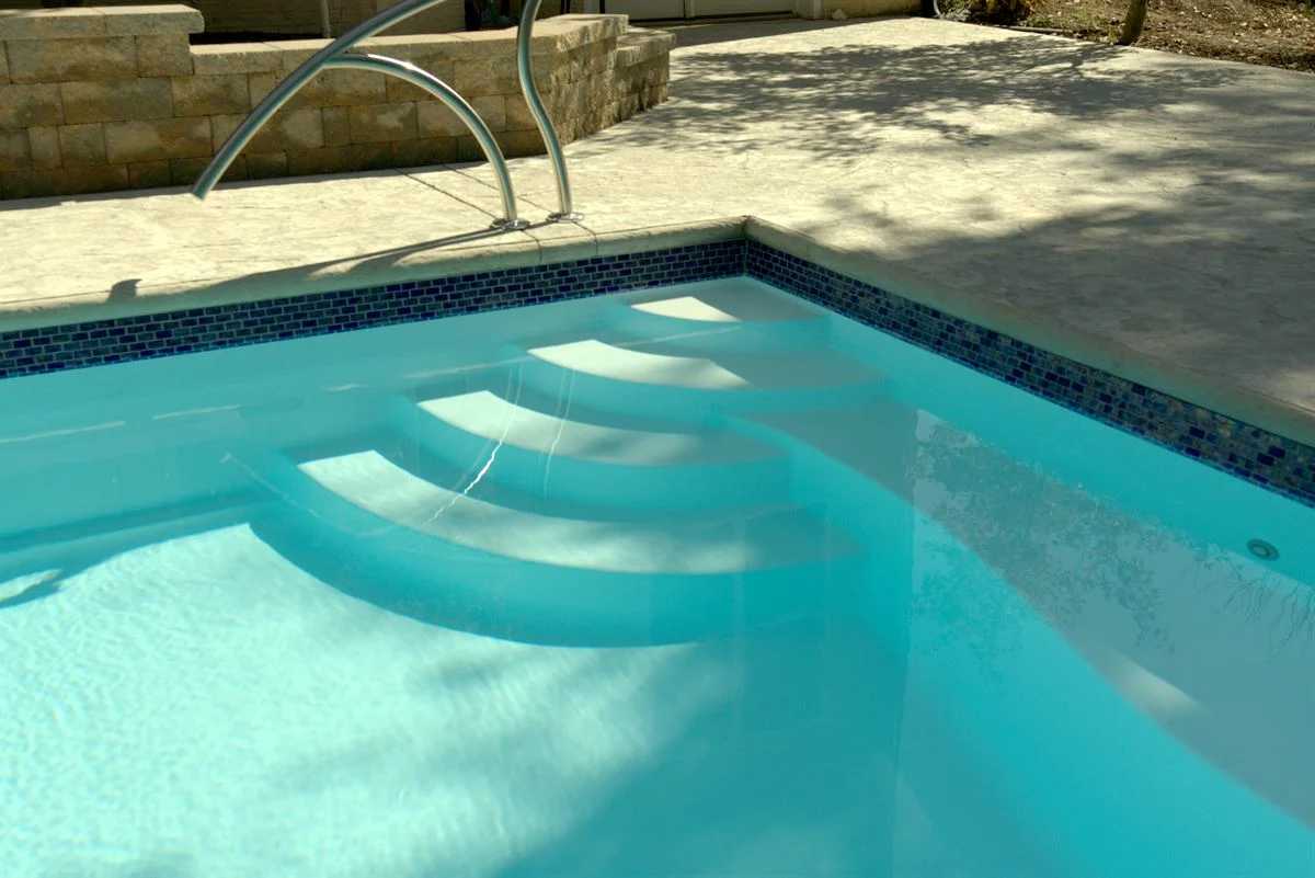 R36 pool in Arctic with textured concrete deck and waterline tile