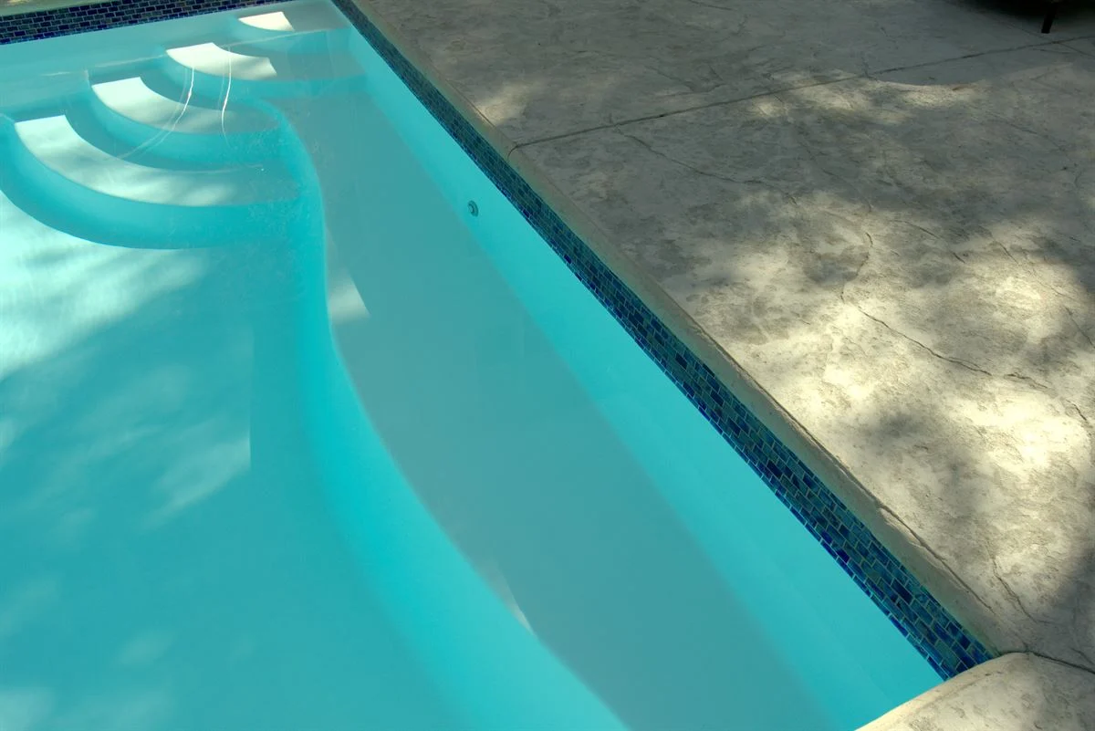 R36 pool in Arctic with textured concrete deck and waterline tile