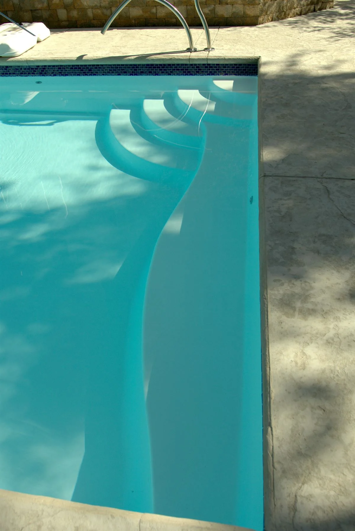 R36 pool in Arctic with textured concrete deck and waterline tile