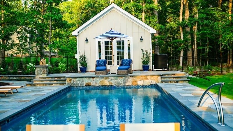 T40 pool in Diamond color with a pool house in the background