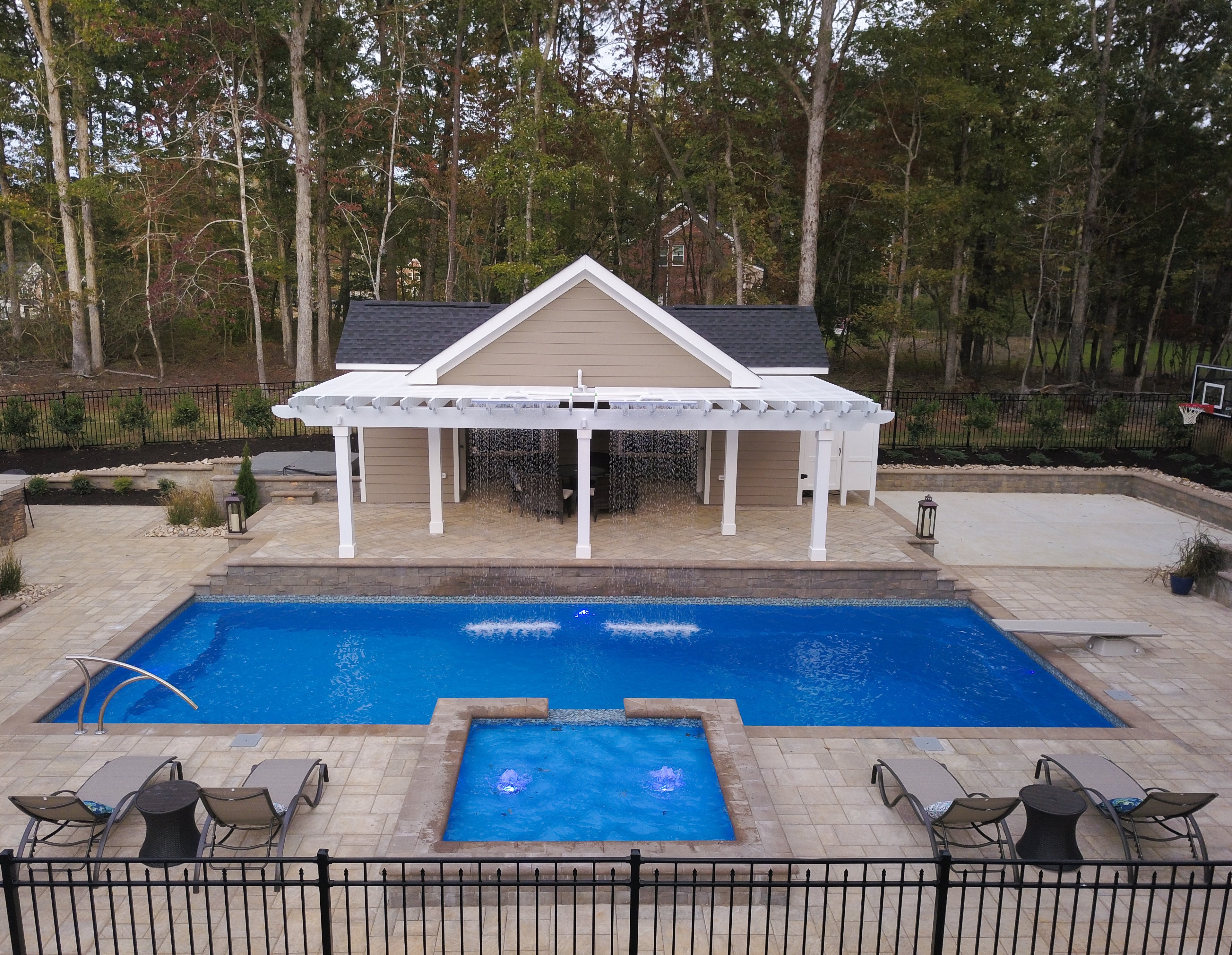 T40 pool with a waterfall and a tanning ledge with bubblers and a spillway