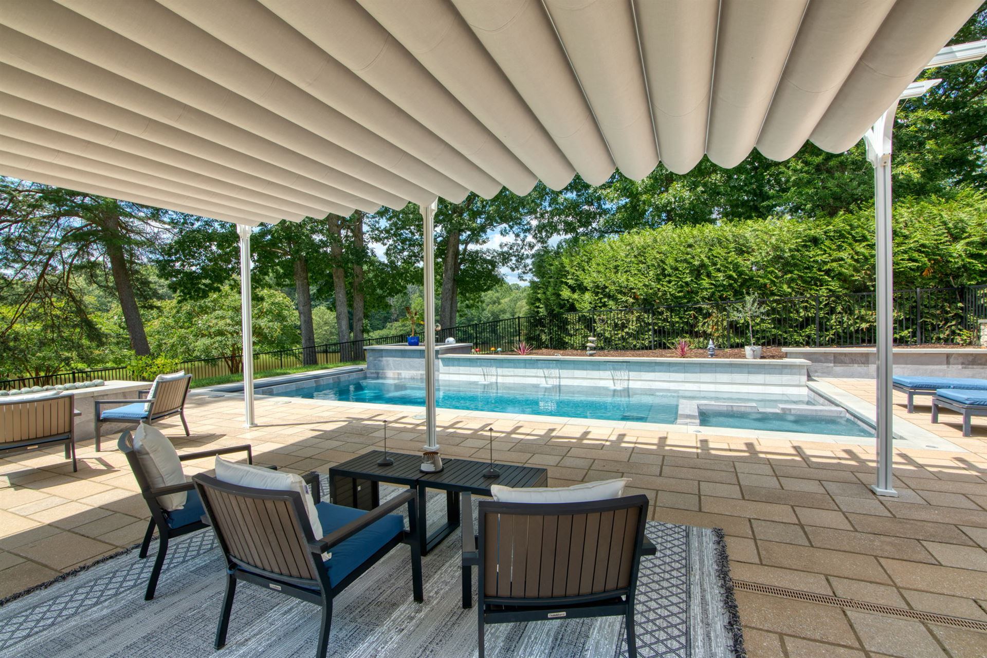 River Pools X36 in Diamond color with cascade, concrete paver patio, and natural stone coping