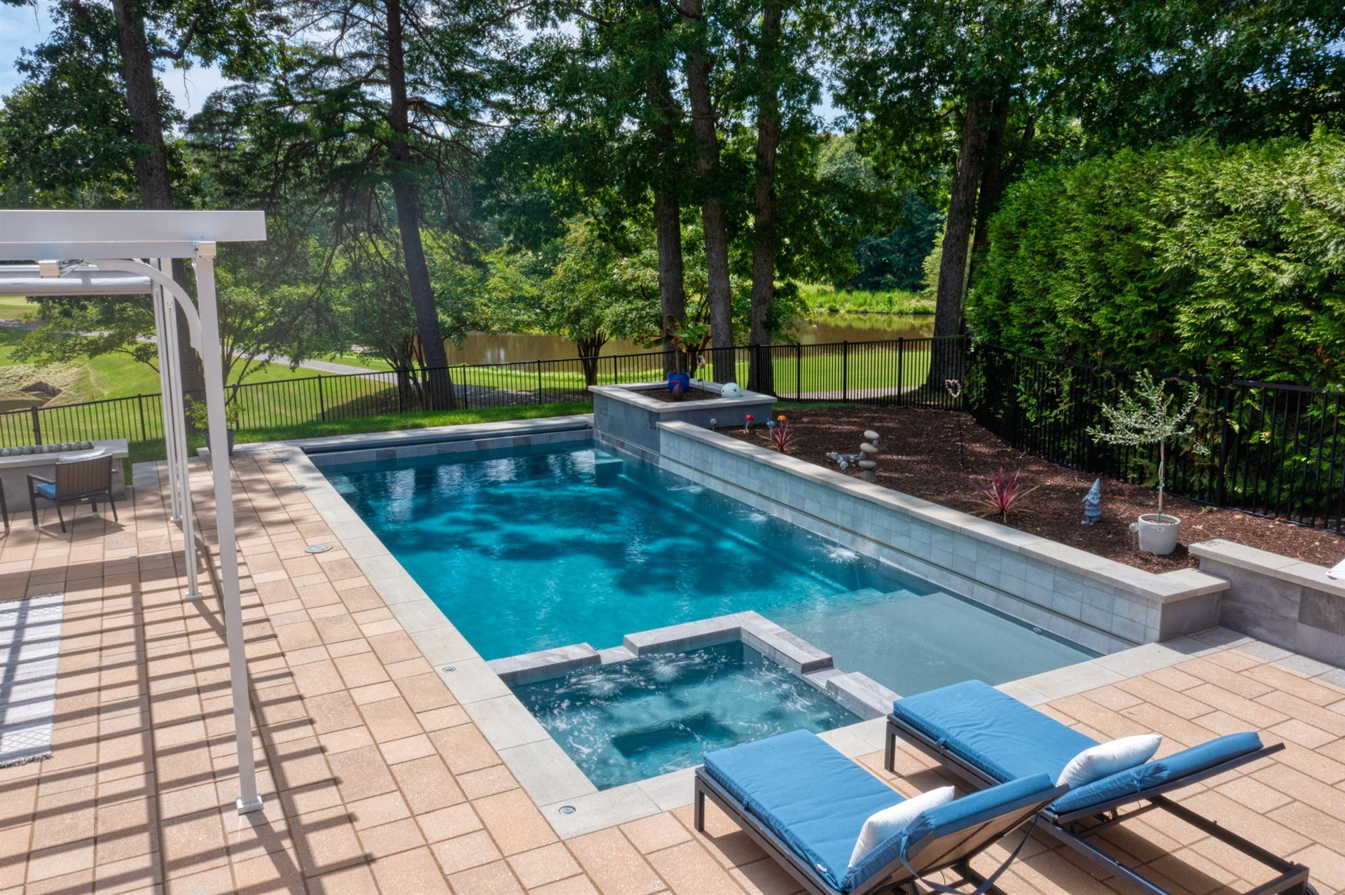 River Pools X36 in Diamond color with cascade, concrete paver patio, and natural stone coping