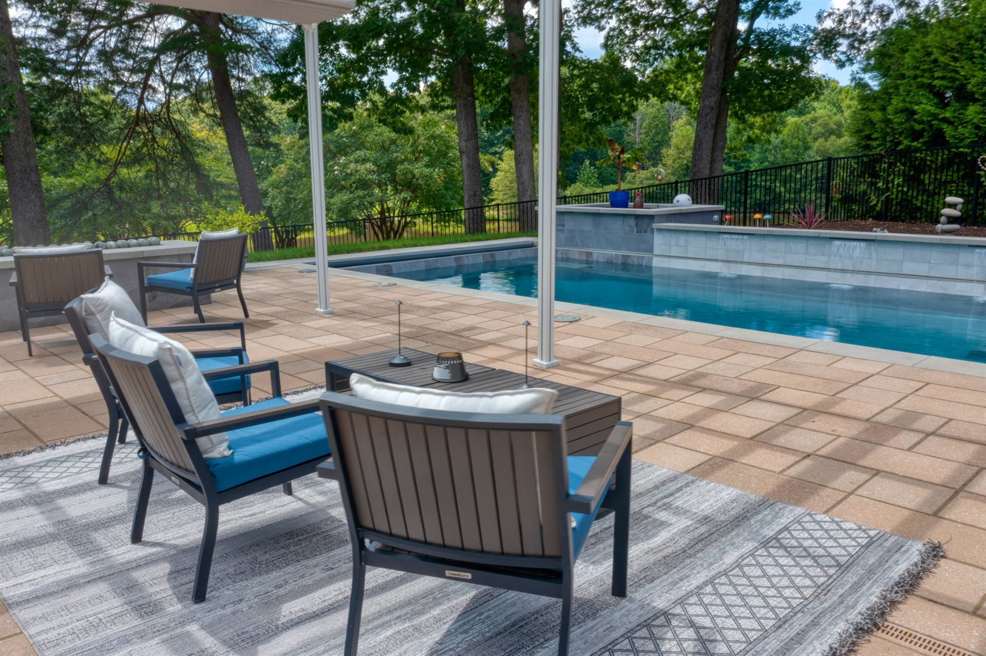 River Pools X36 in Diamond color with cascade, concrete paver patio, and natural stone coping