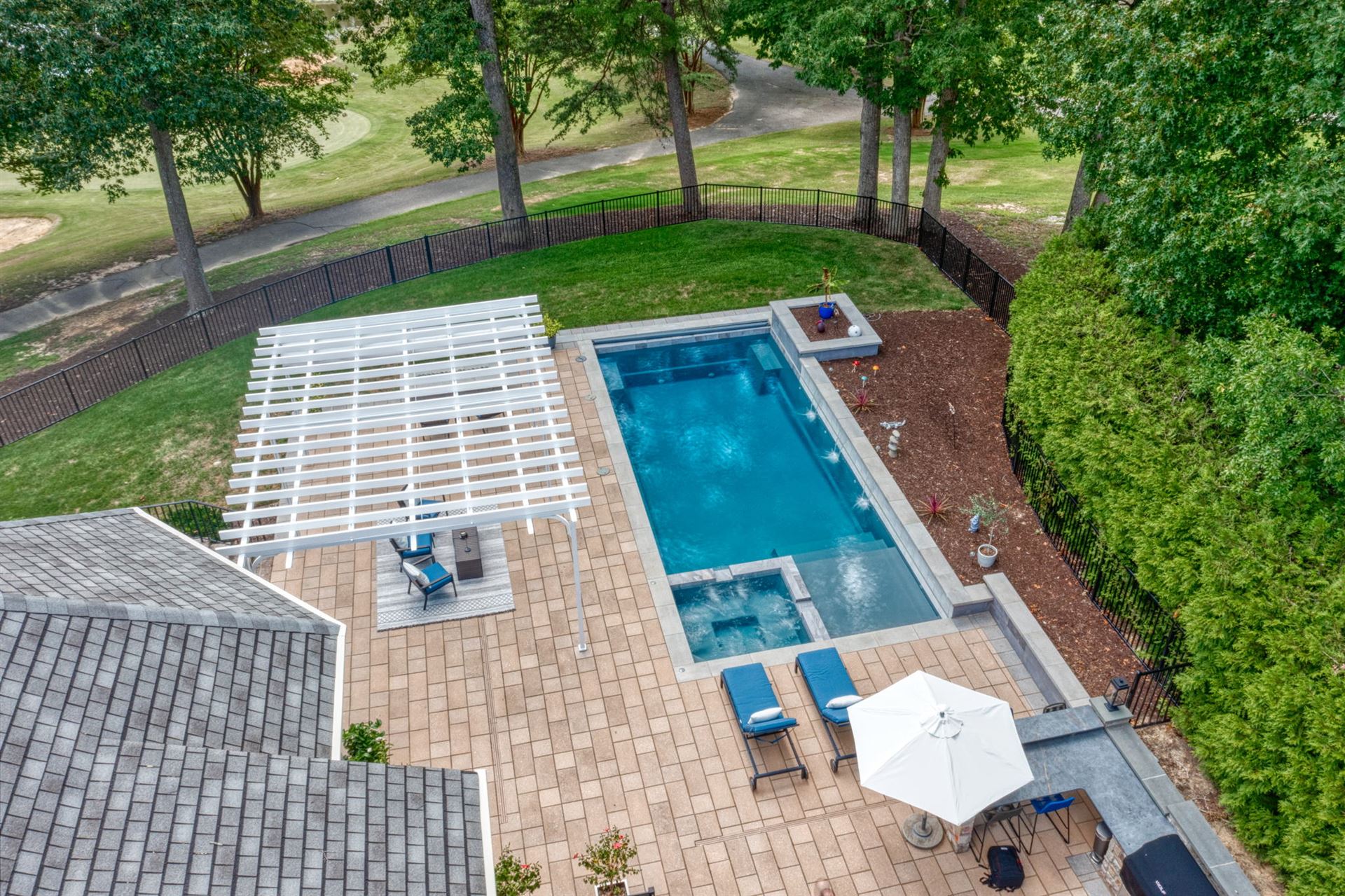 River Pools X36 in Diamond color with cascade, concrete paver patio, and natural stone coping